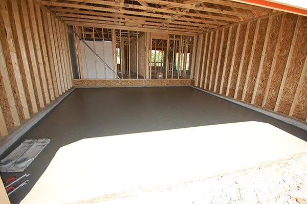 Pour garage and porch floors new home construction