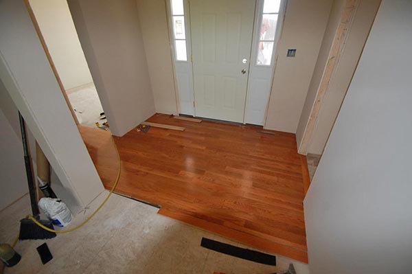 Install flooring (wood, tile) in a newly built home in Indiana